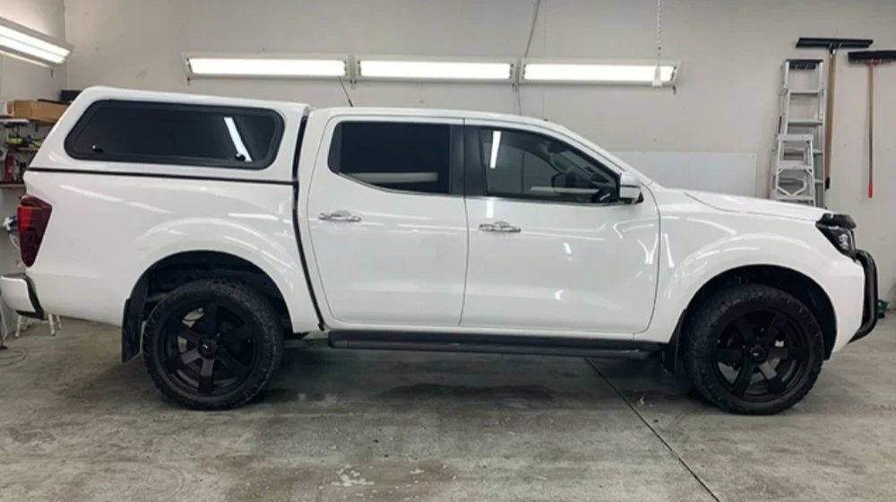 White Nissan Navara ute freshly tinted in the workshop