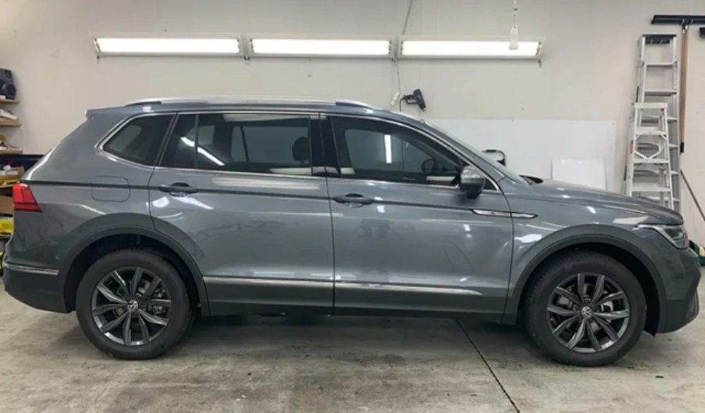 Grey VW Tiguan SUV with dark tinted windows